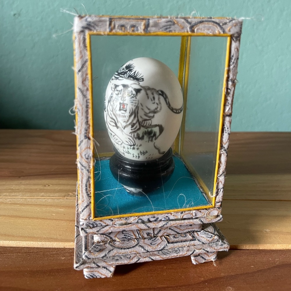 CHINESE HAND PAINTED EGG WITH A TIGER IN A ENCLOSED GLASS CASE 3x5x3”